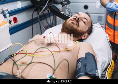 Paramedic attending to patient in ambulance. Stock Photo
