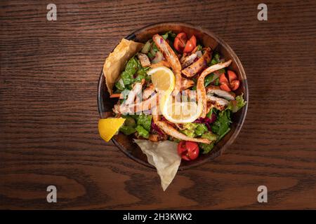Healthy chicken salad on rustic wooden kitchen table Stock Photo