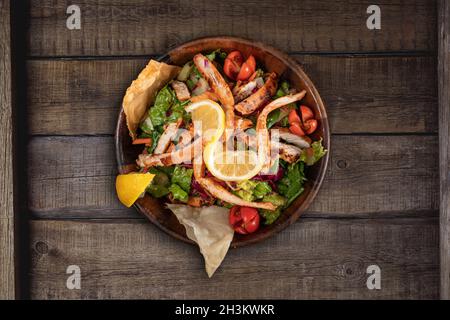 Healthy chicken salad on rustic wooden kitchen table Stock Photo