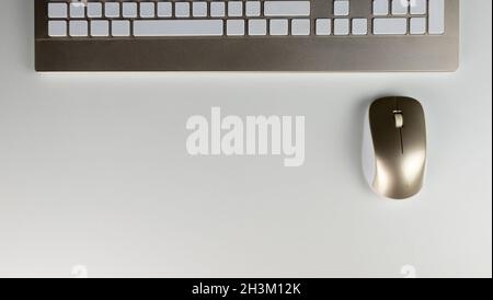 Stock photography of stylized white office table with blank notepad and pen and keyboard and mouse Stock Photo