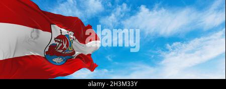 flag of Bremerhaven at cloudy sky background on sunset, panoramic view. Federal Republic of Germany. copy space for wide banner. 3d illustration Stock Photo