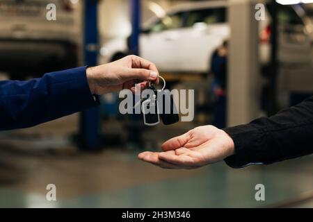 Car key handover, a transport ownership or leasing concept Stock Photo