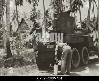 A vintage photo circa 1942 showing soldiers of the 2nd battalion of Argyll & Sutherland Highlanders British Army in the jungle next to a Lanchester 6x4 armoured car during the Japanese invasion of Malaya and the fall of Singapore Stock Photo