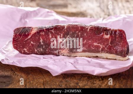 Raw steak on pink paper Stock Photo
