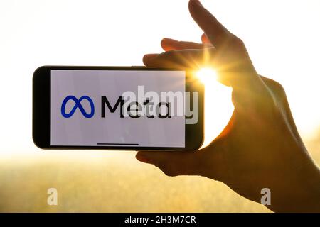 Meta logo on the iPhone. Woman holding smartphone with new faceboo…