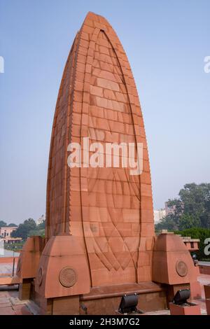 The Martyr's Memorial at Jallianwala Bagh in the city of Amritsar in the Punjab region of India. A plaque on the memorial reads: “This site is saturat Stock Photo