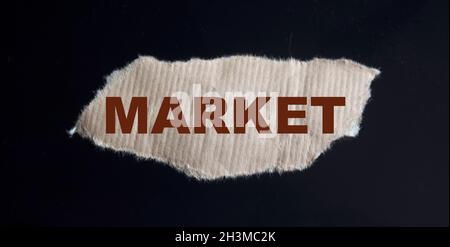 Market text on scrap of paper and black glass background Stock Photo