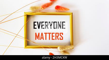 The phrase Everything Matters written in red ink on a photo frame and white background in a vintage frame with ears of wheat Stock Photo