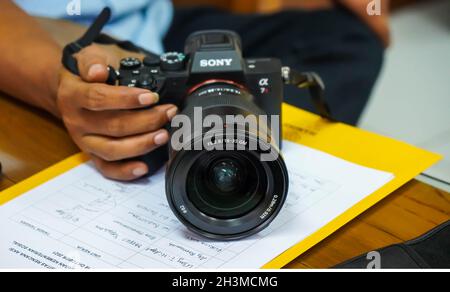 Jakarta 22th june 2021, a man holding his sony alpha camera in selective focus Stock Photo