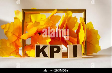KPI text on a yellow background on wooden cubes Stock Photo