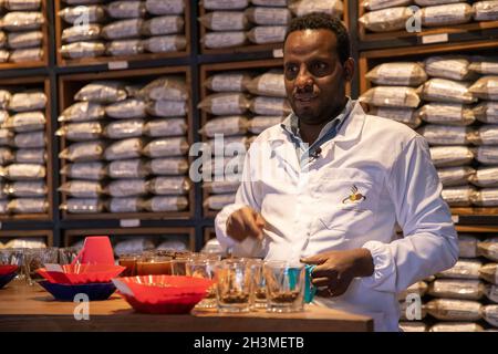 Addis Ababa, Ethiopia. 21st Oct, 2021. Bacha Lencha, a senior coffee quality controller at Kerchanshe Trading Private Limited Company, checks the quality of coffee at a coffee processing plant of the company in Addis Ababa, Ethiopia, Oct. 21, 2021. TO GO WITH 'Interview: Ethiopian coffee exporter eyeing Chinese market' Credit: Michael Tewelde/Xinhua/Alamy Live News Stock Photo