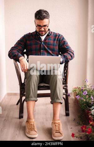 Man using laptop computer at home Stock Photo
