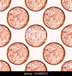 Pink himalayan salt in round wooden bowl repeat seamless pattern on light background Stock Photo