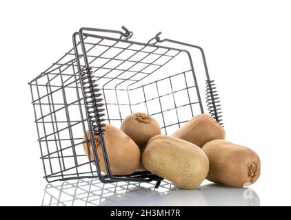 Several juicy organic kiwis with a basket, close-up, isolated on white. Stock Photo