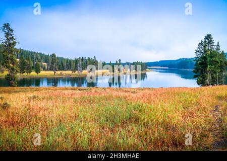 Small mountain meadows and forests to the shores of a picturesque little lake Stock Photo