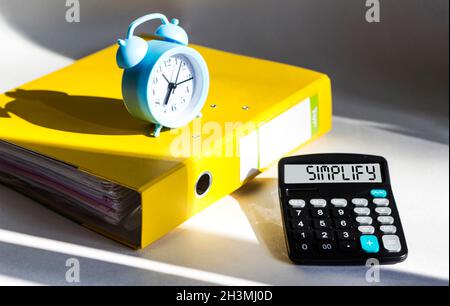 Simplify, word on calculator display. Brainstorming planning Stock Photo