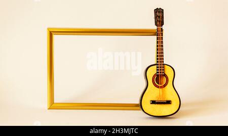Decorative gold frame for photo or recording with guitar on white background Stock Photo