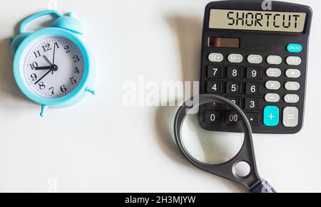 Shortcut word written on the display of a calculator and on a white background, Stock Photo