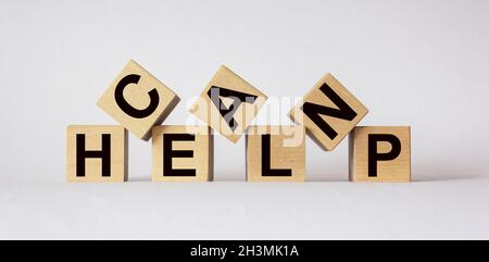 Can help, message on wooden blocks on white background Stock Photo