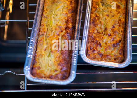 Vegetable pie with roasted peppers on top. Two quiche molds in the oven. Healthy homemade food. High quality photo Stock Photo
