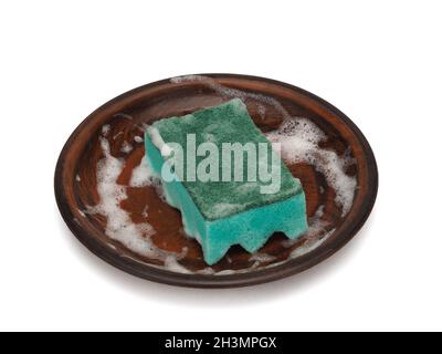 Scouring sponge in foam on a plate, dishwashing Stock Photo