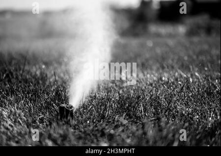 winterizing a irrigation sprinkler system by blowing pressurized air through to clear out water Stock Photo