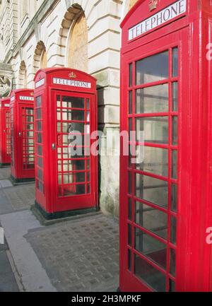 A line of typical old fashioned british red public telephone boxes outside the former post office in Blackpool Lancashire Stock Photo