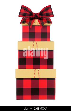 Stack of red and black buffalo plaid Christmas gift boxes with lid and bow. Side view isolated on a white background. Stock Photo