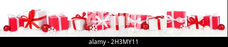 Christmas border of red and white gift boxes in snow. Side view isolated on a white background. Stock Photo