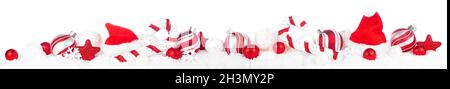 Christmas border of red and white decorations in snow. Side view isolated on a white background. Stock Photo
