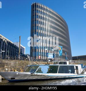 Excursion boat on the River Spree in Berlin. In the background the office building Spreedreieck Stock Photo