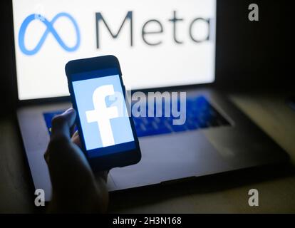 Old Facebook company logo on a mobile phone against the background of the new META logo on a laptop. Nizhny Novgorod, Russia - October.29.2021. Stock Photo
