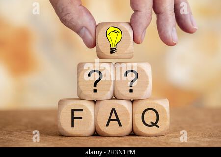 Frequently asked questions printed on wooden cubes Stock Photo