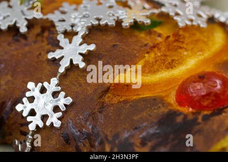 Close-up of a piece of Roscón de Reyes, a typical cake of the Epiphany of the Kings (January 6) in Spain, decorated with candied fruits and a silver g Stock Photo