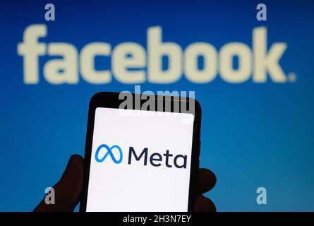 California, USA, 29 October 2021. In this photo illustration, the Meta logo is displayed on the screen of an smartphone in front of a Facebook logo. Facebook to change corporate name to Meta. Stock Photo