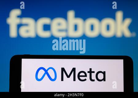 California, USA, 29 October 2021. In this photo illustration, the Meta logo is displayed on the screen of an smartphone in front of a Facebook logo. Facebook to change corporate name to Meta. Stock Photo