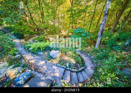 Stone steps and stone garden in forest during fall Stock Photo