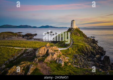 Twr Mawr Lighthouse on Llandwyn Island, Snowdonia at beautiful sunset. This one of the best spots to visit in Anglesey. Stock Photo
