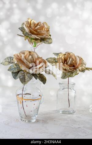 Golden roses in glass vases. Stock Photo