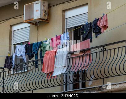washing line, hanging washing, laundry, laundry day, greek flat, washing outside block of flats, laundry on apartment balcony, washing drying in wind. Stock Photo