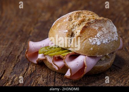 Bavarian liver cheese roll on wood Stock Photo
