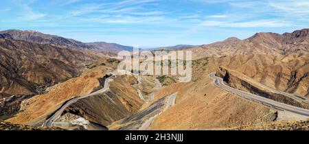 Panorama of Tizi n'Tichka mountain pass in High Atlas range, Morocco - serpentine curved roads over hills Stock Photo