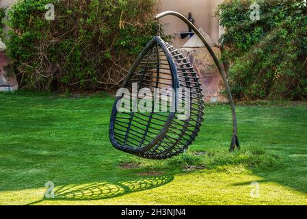 Hanging chair in the garden Stock Photo