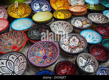 Handmade colourful decorated bowls or cups on display at traditional souk - street market in Morocco Stock Photo