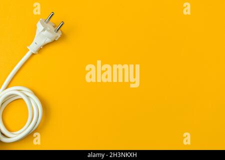 Electrical power cable with EU plug on a flat orange background, top view, copy space Stock Photo