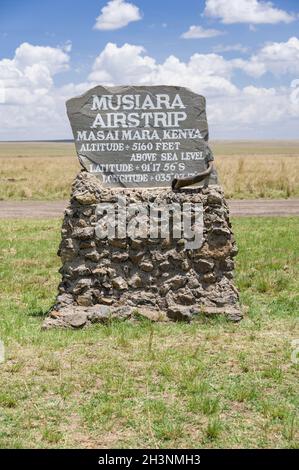 Musiara airstrip stone sign with details of location and altitude, Masai Mara, Kenya Stock Photo