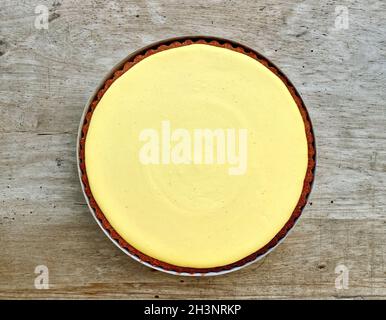 fresh whole lemon tart on wooden kitchen table, top view Stock Photo