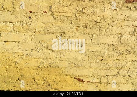 Old brick walls painted in ocher color. Creative vintage background. Stock Photo