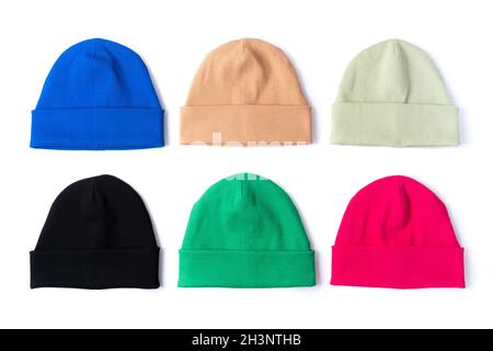 Stylish beanie hats in different bright colors are isolated on a white background. Top view ready for layout. Stock Photo