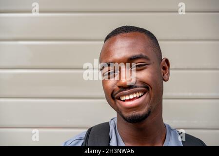 Portrait of afro young man smiling outdoors Stock Photo